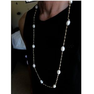 Long pearl necklace.